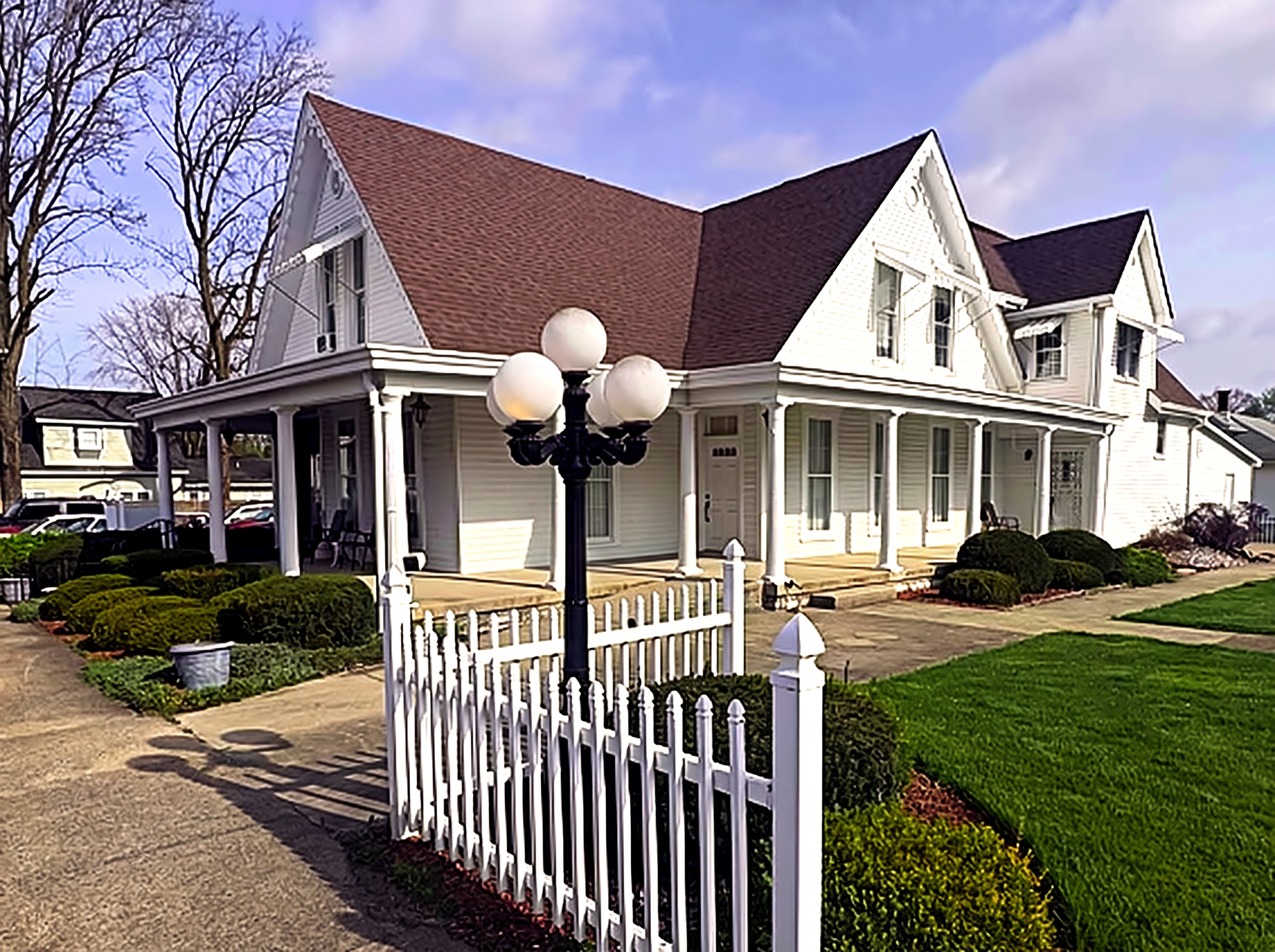 The Glenn E. George Funeral Home building with white picket fence